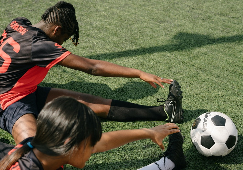 Two girls are doing exercises in football